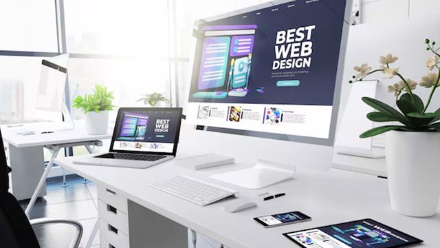 Designer laying out a responsive business website in a design tool